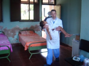 Dr. Frenzel in Bolivia holding young girl