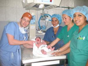 Dr. Frenzel Holding Up Newborn